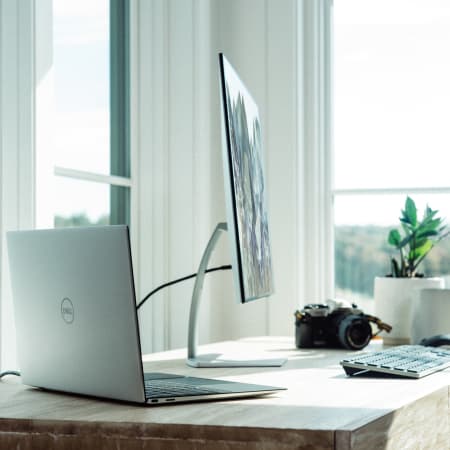 Photo of computer and laptop on desk